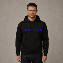 Lae piltide sirvija Man wearing a personalized black unisex hoodie with blue HOMETOWN text
